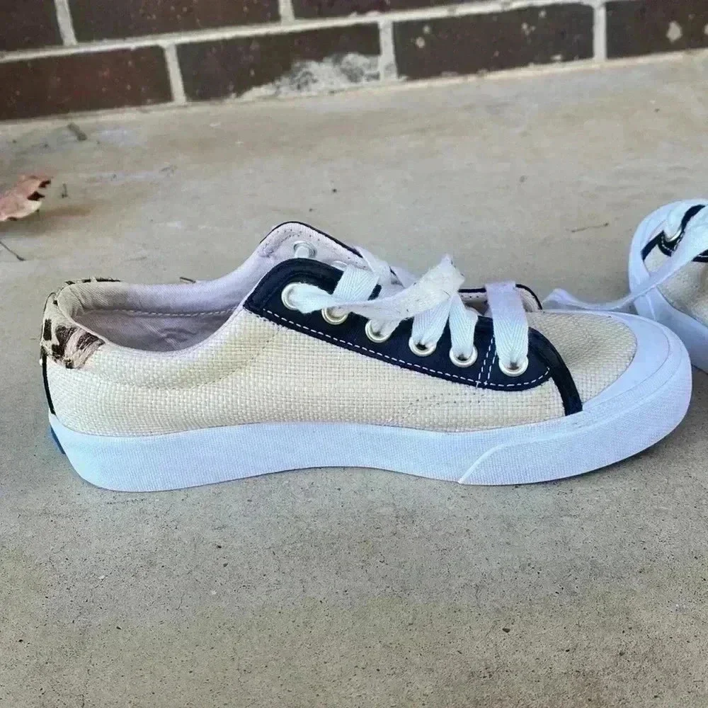 Keds beige canvas sneakers with black trim and leopard heel
